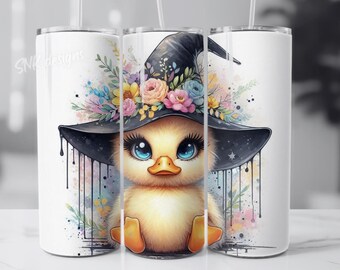 May include: A white tumbler with a colorful illustration of a duck wearing a witch's hat with flowers. The duck has blue eyes and a yellow beak. The background is a watercolor wash of pink, blue, and yellow.