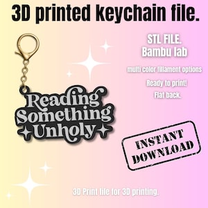 May include: A black keychain with the words "Reading Something Unholy" in white, attached to a gold-colored clasp. The image also includes text that says "STL FILE", "Instant Download", and "3D printed keychain file."