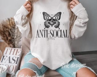 May include: A white long-sleeved sweatshirt with a black and white butterfly graphic with a skull in the center. The text "Anti-Social Butterfly" is printed below the butterfly.