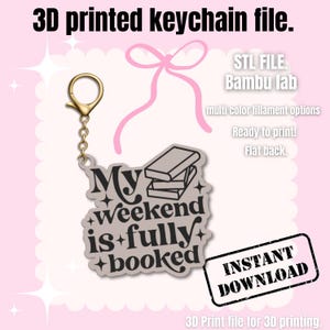 May include: A 3D-printed keychain file with the text "My weekend is fully booked." The keychain has a gold-coloured clasp and chain. The design includes a stack of books and decorative stars. The image also includes the text "INSTANT DOWNLOAD".