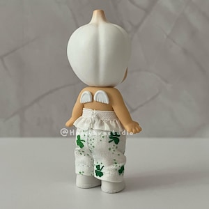 May include: A white ceramic mug with a black handle and the text "But First, Coffee" in a handwritten style. The mug is on a white surface. The mug is approximately 4 inches tall.