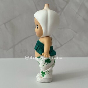 May include: A set of three ceramic mugs with a speckled, matte finish. The mugs are in shades of cream, light gray, and dark gray. Each mug has a simple, modern design and a rounded handle. The mugs are stacked on top of each other.