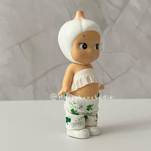 May include: A set of three ceramic mugs with a speckled, matte finish. The mugs are in shades of cream, light gray, and dark gray. Each mug has a simple, minimalist design and a rounded handle.