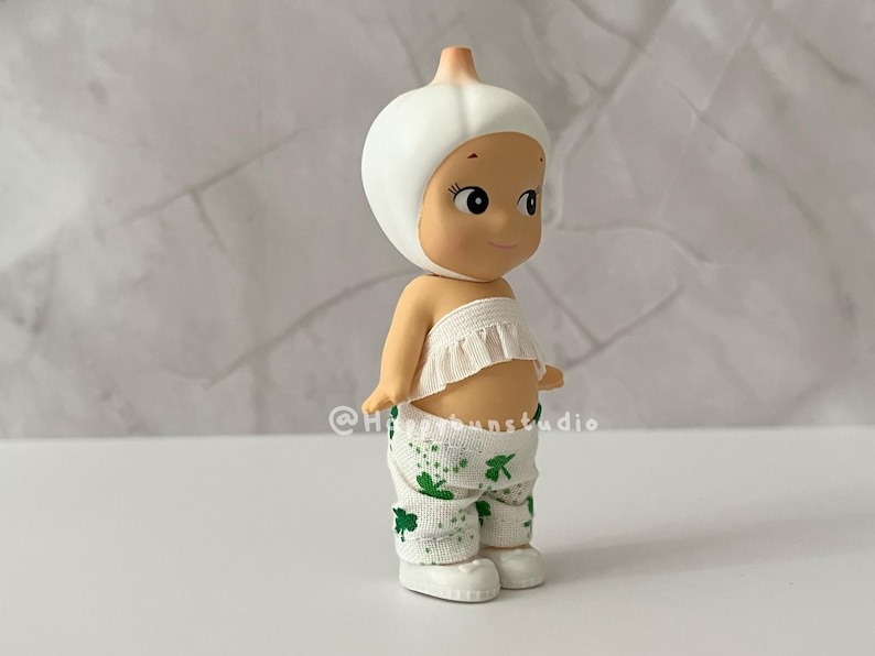 May include: A set of three ceramic mugs with a speckled, matte finish. The mugs are in shades of cream, light gray, and dark gray. Each mug has a simple, minimalist design and a rounded handle.