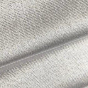 May include: Close-up of a silver fabric with a subtle textured pattern. The fabric is smooth and has a slight sheen.