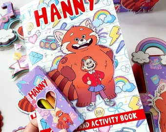 May include: A colorful activity book with a red panda and a girl on the cover. The book is titled "Hanny and Activity Book". A small box of crayons is included, also with a red panda design and the name "Hanny" on it.