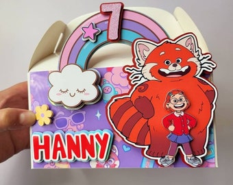 May include: A colorful party favor box with a rainbow, a cloud, a red panda, and a girl character. The box is decorated with a pink star, a glittery number 7, and the name "HANNY".