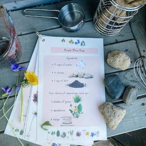 May include: A printable recipe card for Simple Stone Soup with illustrated ingredients including 3 cups of water, 4 stones, 1 cup of dirt, blades of grass, dandelions, and twigs.