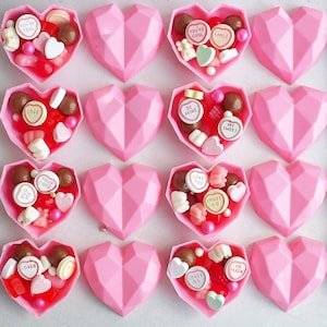 May include: Pink heart-shaped chocolate boxes filled with assorted candies, including heart-shaped candies with messages like "True Love", "Be Mine", "Love You", and "Crazy 4U".