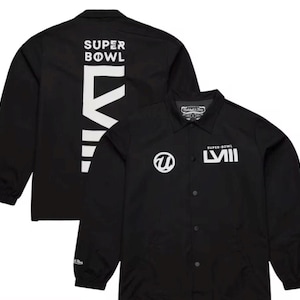 May include: Black coach jacket with white text and logos. The back of the jacket features the words "SUPER BOWL" above a large white graphic. The front displays the Super Bowl logo and the Roman numeral "LVII".