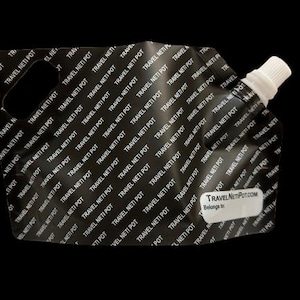 May include: A black, reusable, travel-sized neti pot with a white spout and a label that reads "TravelNetiPot.com Belongs to".