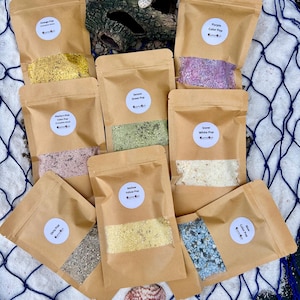 May include: A set of three ceramic mugs with a speckled, matte finish. The mugs are in shades of blue, green, and white. Each mug has a simple, modern design, perfect for coffee or tea.