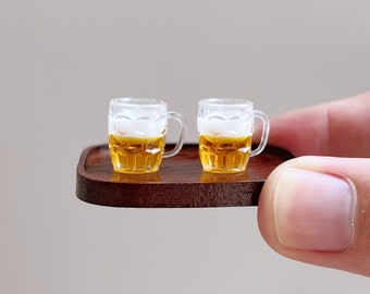 May include: Two miniature glass beer mugs filled with a light-colored beer on a wooden tray.