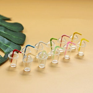 May include: A set of 12 miniature clear plastic cups with colourful bendy straws. The cups are perfect for dollhouse or miniature play sets.