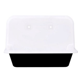 May include: A white plastic container with a black base. The container has a rectangular shape with rounded corners and a slightly curved lid. Two small square holes are visible on the lid.