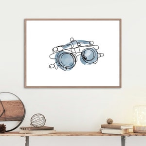 May include: A line drawing of an eye exam tool with blue watercolor accents. The tool is used to test vision and is often found in an optometrist's office.