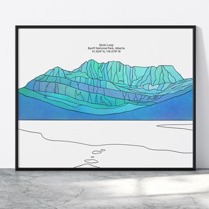 May include: A line art illustration of a mountain range in blue and green hues. The text "Skoki Loop, Banff National Park, Alberta 51.5047° N, 116.0719° W" is at the top of the image.