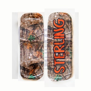 May include: Two camouflage-patterned trays with a black outline. One tray has the word "STERLING" in orange letters.
