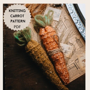 May include: Two knitted carrots, one orange and one brown, with green tops. The carrots are lying on a vintage newspaper background. The image includes the text "Knitting Carrot Pattern PDF".