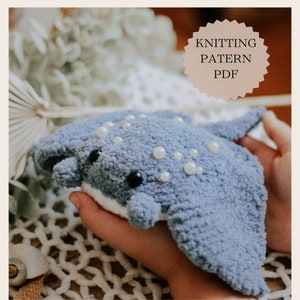 May include: Knitting pattern PDF for a blue crocheted stingray with white pearl embellishments.