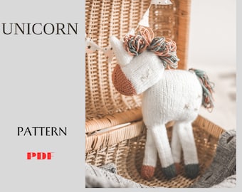 May include: A white knitted unicorn toy with a brown nose, green and brown mane, and a white star on its side. The unicorn is sitting in a wicker basket.