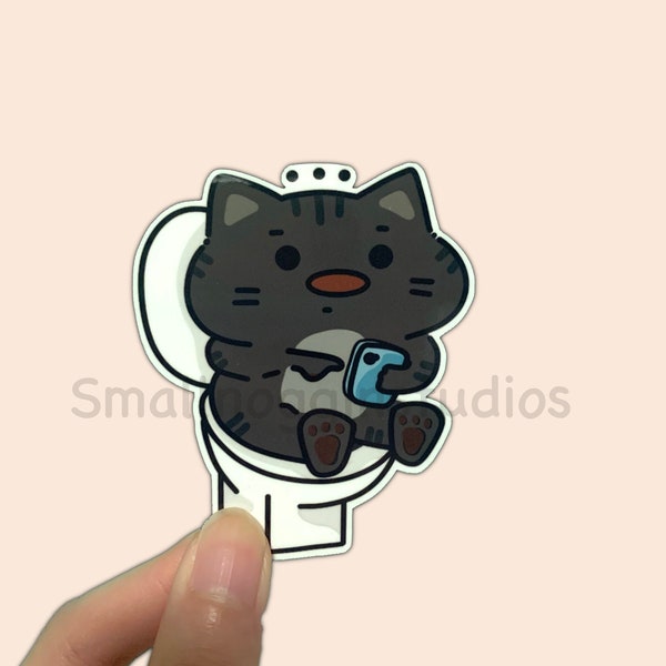 Cat on the toilet Vinyl Sticker - Poop meme, funny grey/black cat on toilet with phone, cute gif sticker, dishwasher safe, water bottle safe