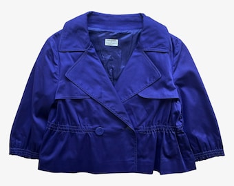 May include: A vibrant blue jacket with a double-breasted design. The jacket features a notched collar, three-quarter sleeves, and a cinched waist with a single button closure. The interior label reads "Paloma Picasso".
