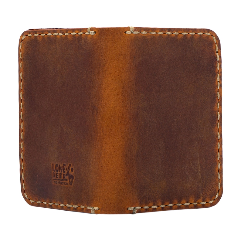 Our wallet features traditional antique details such as burnished edges in the body of the wallet. This wallet also features our finest needlework and is small and discreet enough for a hip or jacket pocket.