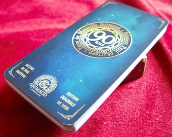 Op de afbeelding: Een blauwe en gouden tarotdeckdoos met de tekst "Tarot de Marseille Grimaud Edition Paul Marteau 90 ans" en "Editions Originale de 1930".