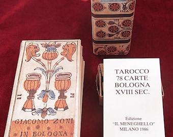 May include: A deck of vintage tarot cards with a decorative box and a booklet. The cards feature illustrations of chalices, lions, and floral designs. The box and cards have text in Italian, including "Tarocco di 78 Carte Bologna XVIII Sec."