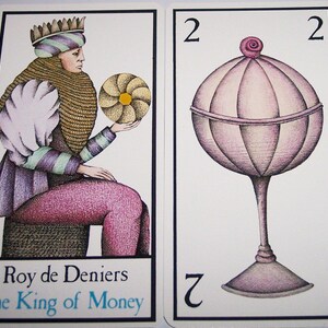 May include: Two tarot cards. The first card shows a figure in purple and green attire, holding a golden disc. The text at the bottom reads "Roy de Deniers" and "The King of Money". The second card depicts a stylized goblet with a pink, orb-like top and the number "2" at the top and bottom.