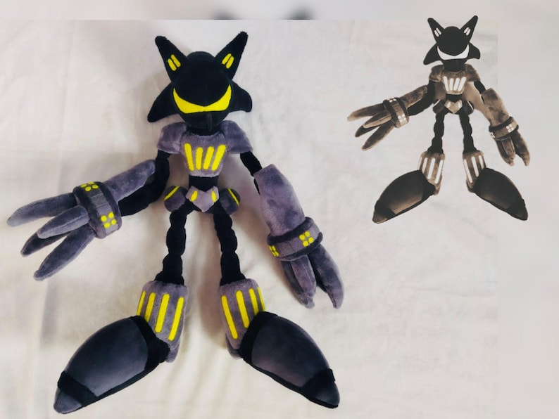 May include: Two plush toys of a robot character. The larger one is mainly black and grey with yellow accents, including on the chest and feet. The smaller one has a similar design, but in a darker colour palette.