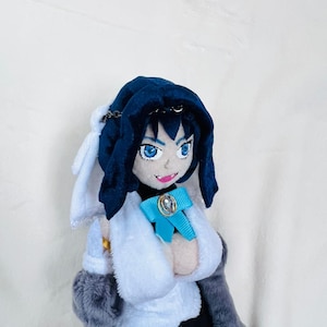 May include: A plush toy with blue hair, a blue hooded cloak, a white shirt, a blue bow, and a gray coat.
