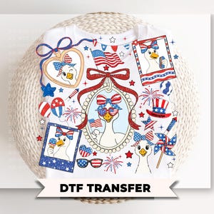 May include: White t-shirt featuring a patriotic goose design with sunglasses, bows, and American flag elements. The design includes stars, fireworks, and the text "DTF TRANSFER".