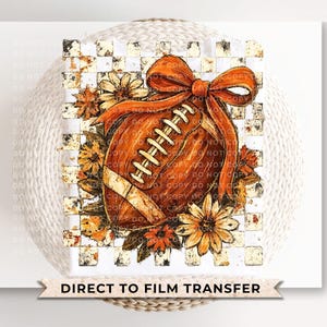 May include: A watercolor design featuring a football with a large orange bow, surrounded by fall flowers. The football is brown with white laces. The background is a checkered pattern. Text at the bottom reads "DIRECT TO FILM TRANSFER".
