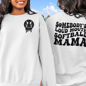A direct to film transfer that says Somebody's Loud mouth Softball Mom. Back and front option. Front design is of baseball smiley face. The DTF transfer is a cold peel ready to press transfer.