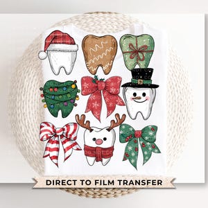 May include: White t-shirt featuring various Christmas-themed tooth designs. The designs include a tooth wearing a Santa hat, a gingerbread tooth, a tooth wrapped as a gift, and a tooth decorated as a Christmas tree. The text "DIRECT TO FILM TRANSFER" is at the bottom.