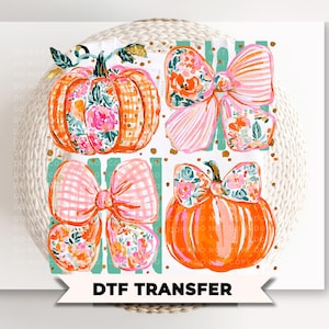 May include: A DTF transfer sheet featuring a graphic design of two orange pumpkins and two large bows. The pumpkins and bows are decorated with floral patterns and pink gingham checks. Gold dots and teal vertical stripes accent the background.