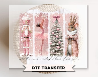May include: A white DTF transfer with a festive design. It features a pink Nutcracker, a ballerina, a Christmas tree with pink baubles, and a mouse wearing a crown. The text reads "it's the most wonderful time of the year".