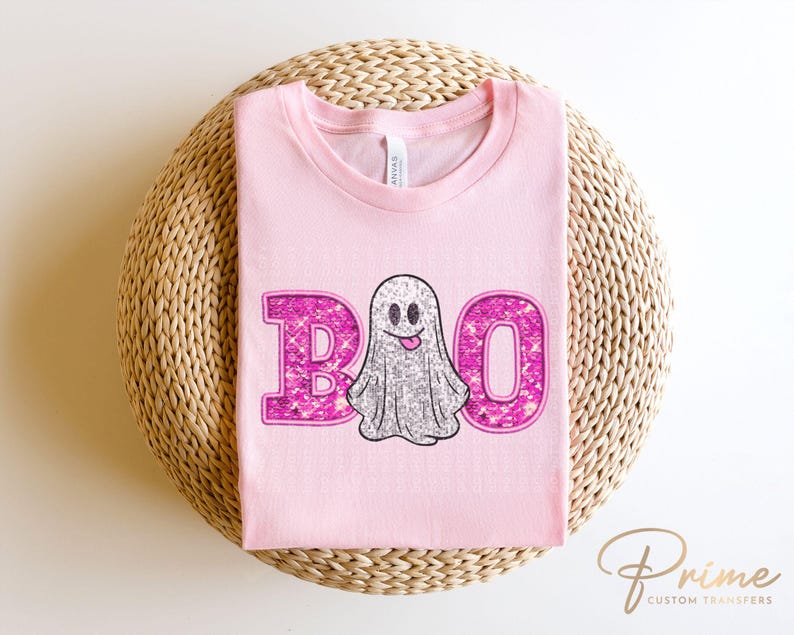 May include: Pink t-shirt with a sparkly pink "BOO" and a sparkly silver ghost with a pink smile.