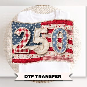 May include: White t-shirt with a patriotic design featuring the numbers "250" in a patchwork style. The design incorporates elements of the American flag with red, white, and blue fabrics. The text "DTF TRANSFER" is at the bottom.