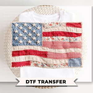 May include: White t-shirt with a sewn-on American flag design. The flag features a blue field with white stars, red and white stripes, and floral and gingham patterns. The text "DTF TRANSFER" is at the bottom.