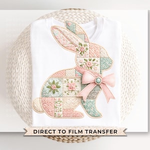 May include: White t-shirt featuring a patchwork bunny design in pastel pink, blue, and green. The bunny has a pink bow with a turquoise center. The design includes floral embroidery. The text "DIRECT TO FILM TRANSFER" is at the bottom.