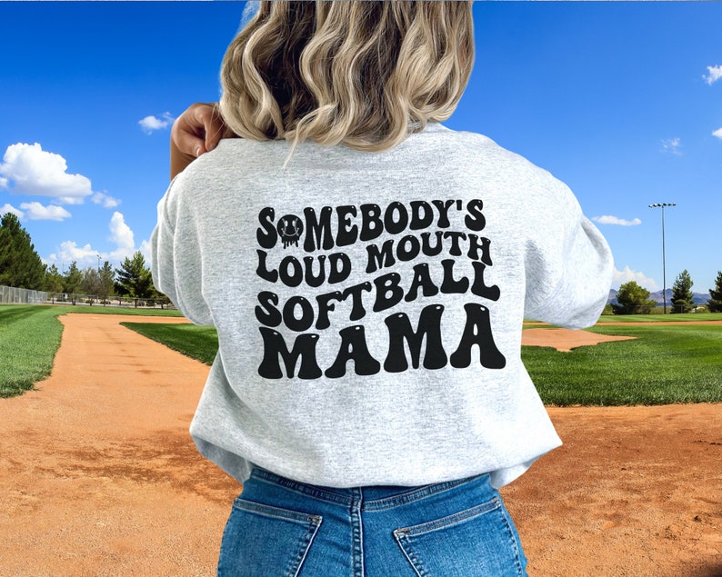 A direct to film transfer that says Somebody's Loud mouth Softball Mom. Back and front option. Front design is of baseball smiley face. The DTF transfer is a cold peel ready to press transfer.