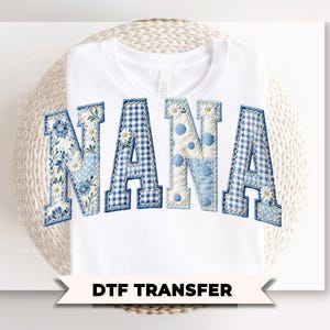 May include: White t-shirt with the word "NANA" in blue patchwork letters. The letters feature floral, gingham, and polka dot patterns. The text "DTF TRANSFER" is displayed below the shirt.