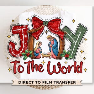 May include: Red, green, and white Christmas-themed graphic with the words "Joy to the World" and a depiction of the nativity scene. The graphic is designed for direct to film transfer.