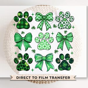 May include: Green and white paw print and bow designs on a white background. The designs are perfect for creating iron-on transfers for t-shirts, tote bags, and other apparel.  Direct to film transfer.
