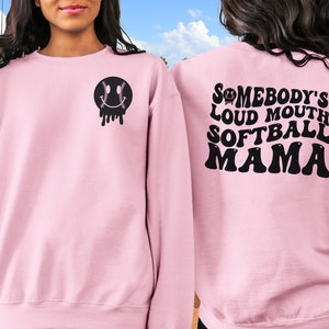 A direct to film transfer that says Somebody's Loud mouth Softball Mom. Back and front option. Front design is of baseball smiley face. The DTF transfer is a cold peel ready to press transfer.