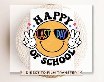 May include: A white t-shirt featuring a yellow smiley face wearing black sunglasses with the text "HAPPY LAST DAY OF SCHOOL" in black, wavy font. The smiley face has white gloved hands making peace signs and small colorful stars around it.