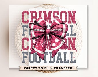 May include: A maroon and white football-themed bow design with the words "CRIMSON FOOTBALL" in maroon and gray. The bow features a football design with the letter "A" and paw prints. The words "DIRECT TO FILM TRANSFER" are at the bottom.
